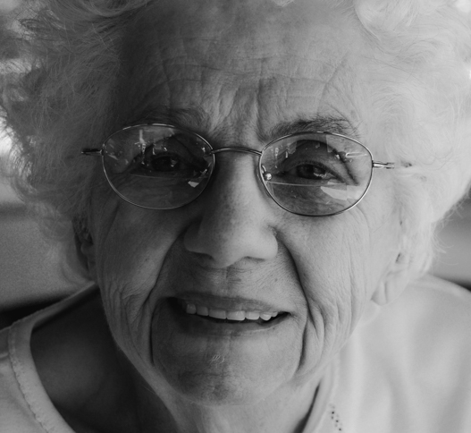 Old woman smiling with glasses 