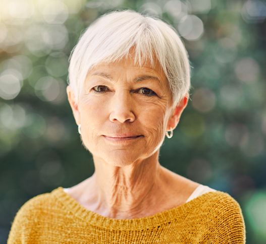 older woman with short hair smiling